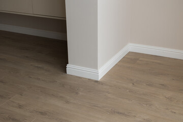Plinth on laminate. the floor of a new apartment