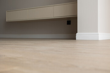 Plinth on laminate. the floor of a new apartment