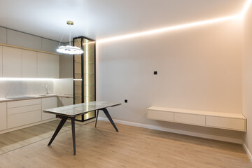 Modern kitchen in the interior of a new apartment in beige tones