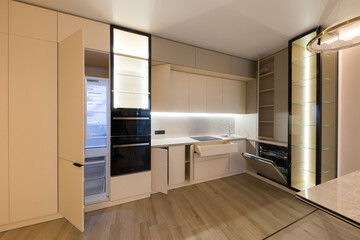 Modern kitchen in the interior of a new apartment in beige tones