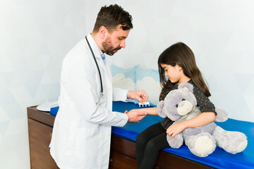 Pediatrician with a kid patient testing for allergies