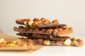 Pieces of various handmade chocolates lined up on the table, chocolate concept