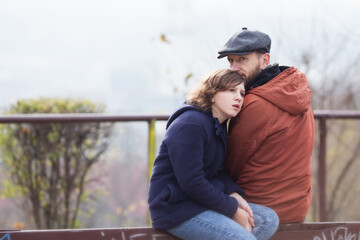 a father spends time with his teenage daughter in an autumn park