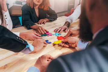 Business team connect pieces of puzzle like a teamwork and partners