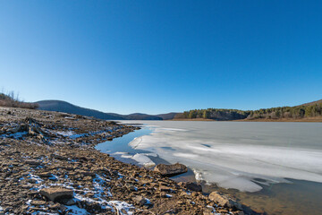 Winter lake landscape calm sunny day during winter season