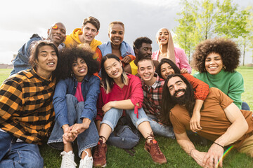 Group of young multiracial friends having fun together in park - Friendship and diversity concept