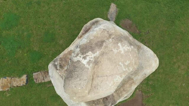 the drone camera moves up, above the boulders of the archaeological site in Bumi Ragem Sai Mangi Wawai, Lampung Indonesia.