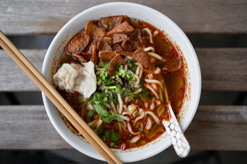 Mala Noodle (Numbing Spicy Noodle) in isolated wooden table background.