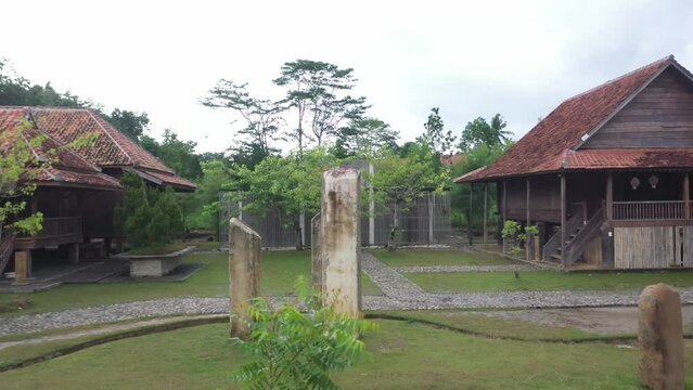 the camera moves to the right around the boulders of the ancient site on Bumi Ragem Sai Mangi Wawai, Lampung Indonesia.