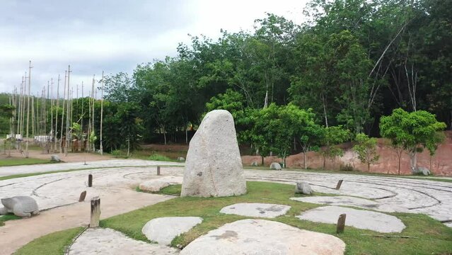 the camera moves to the left around the boulders of the ancient site on Bumi Ragem Sai Mangi Wawai, Lampung Indonesia.