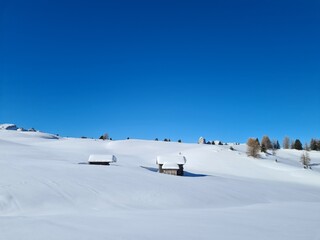 Amazing winter landscape in Italian Alps. Winter panorama with ski huts in the snow. beautiful bright sky in winter wonderland alps.
