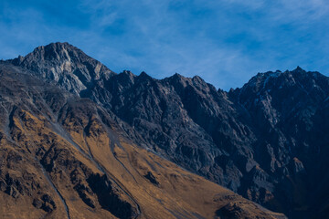 Fototapeta premium Georgia : 10-11-2022 : Country of Georgia, Kazbegi, Panoramic landscape of beautiful natural mountains, view of amazing Caucasus mountain peaks and meadows in Kazbegi national park