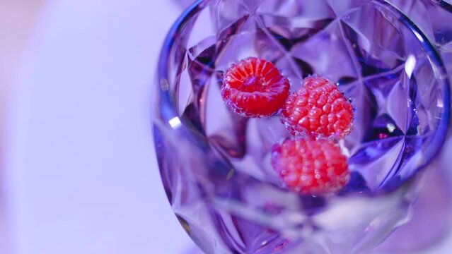 Close-up cocktail with raspberries in a vintage glass