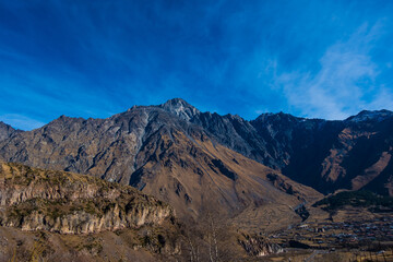 Georgia : 10-11-2022 : Country of Georgia, Kazbegi, Panoramic landscape of beautiful natural mountains, view of amazing Caucasus mountain peaks and meadows in Kazbegi national park