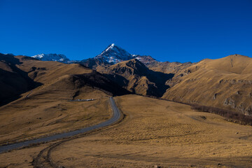 Georgia : 10-11-2022 : Country of Georgia, Kazbegi, Panoramic landscape of beautiful natural mountains, view of amazing Caucasus mountain peaks and meadows in Kazbegi national park
