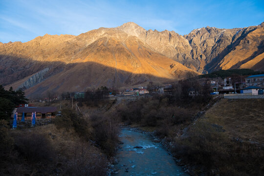Kazbegi, Georgia : 10-11-2022 : Village Of Gergeti In Georgia, with the beautiful Caucasus mountain peaks and meadow surrounded