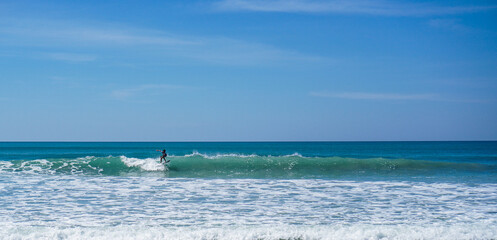 Surfboard kid surfer surfing wave in ocean in summer vacation. Lifestyle sport concept