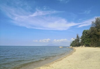 Empty Tropical Public Beach with beautiful blue skies and golden sand located in Langkawi, Malaysia