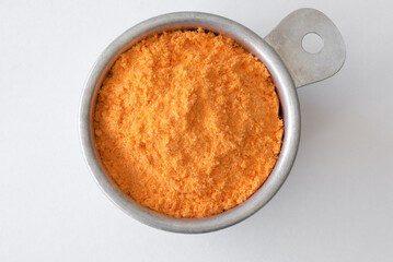 Cheddar Cheese Powder in a Measuring Cup