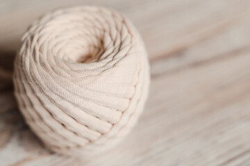 Skein of threads of beige noodle yarn, close-up