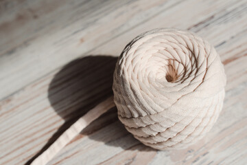 Fototapeta premium Skein of threads of beige noodle yarn, close-up