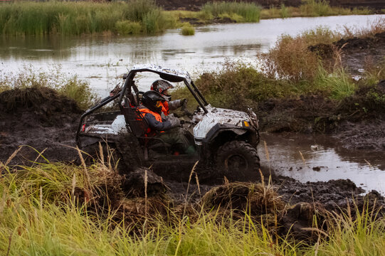 athlete on a ssv rides in the mud