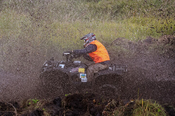 athlete on a quad bike rides in the mud © Елена Вырыпаева
