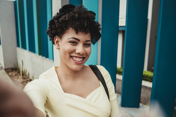 Selfie of a beautiful young latina woman smiling outdoors. 