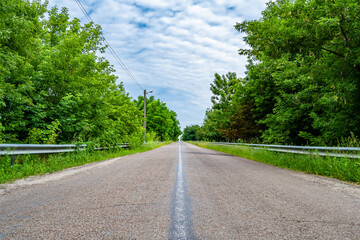 Beautiful empty asphalt road in countryside on colored background