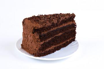 A piece of chocolate cake on a white background. Shallow depth of field