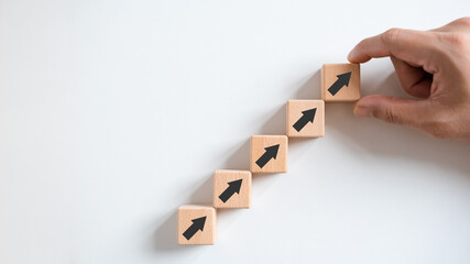 Business growth concept, male hands arranged stacked wooden blocks steps on white table, future...