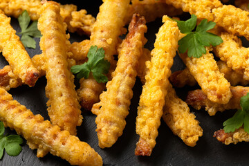 Fried Vegan jackfruit and oyster prawns in crispy batter served on black slate with chili dip sauce