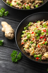 Asian Beef Fried Rice with eggs and vegetables in black bowl