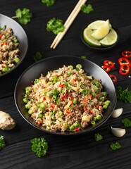 Asian Beef Fried Rice with eggs and vegetables in black bowl