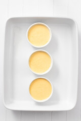Souffle cake mixture in tin before baking, top and vertical view