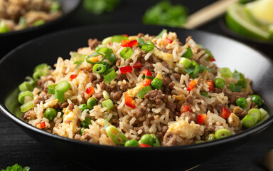 Asian Beef Fried Rice with eggs and vegetables in black bowl