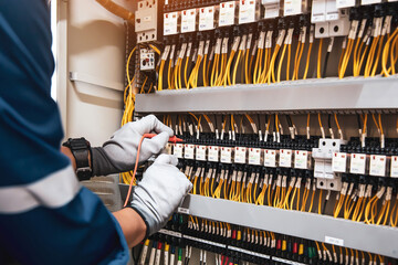 Electricity or electrical maintenance service, Electrician hand checking electric current voltage...