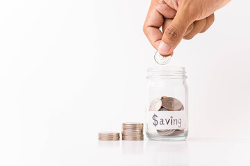 hand putting  money coin into piggy bank with white background, saving money concept, copy space