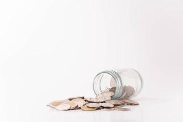 Pile of money coins and piggy bank with white background, saving money and financial concept, copy space