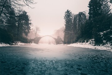 Middle Earth in Winter: An Old Stone Bridge over a Frozen Lake	