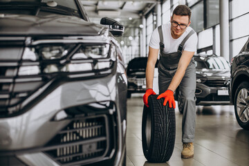 Mechanic changing tires in a car service © Petro