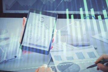 Fototapeta na wymiar Double exposure of man's hands holding and using a digital device and forex graph drawing. Financial market concept.