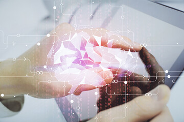 Double exposure of man's hand holding and using a digital device and brain hologram drawing. Data concept.
