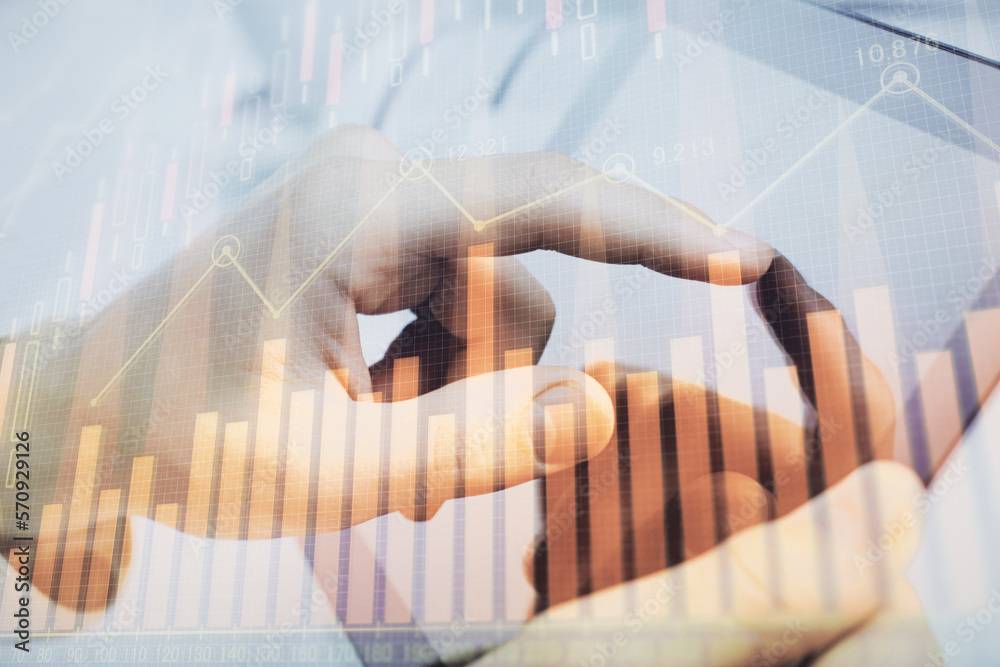 Poster multi exposure of man's hands holding and using a phone and financial chart drawing. market analysis