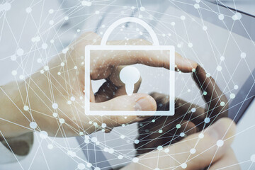 Multi exposure of man's hands holding and using a digital device and lock drawing. Security concept.