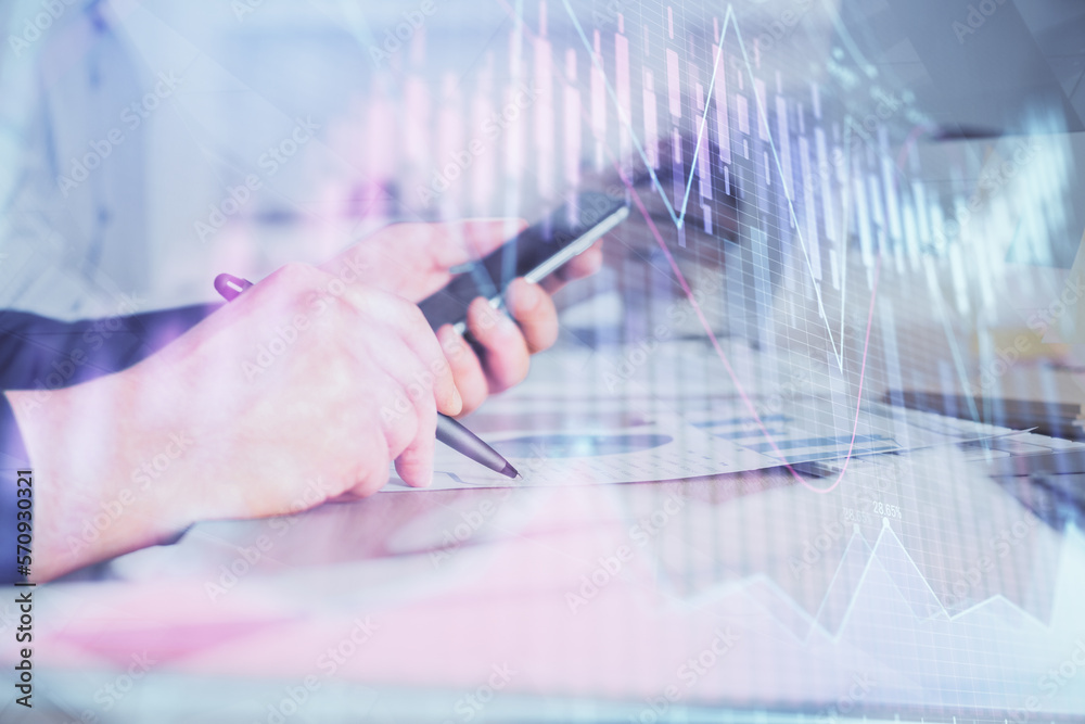 Poster double exposure of man's hands holding and using a phone and financial chart drawing. market analysi