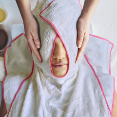 Unrecognizable women at spa wrapped in facial towels - 570932314