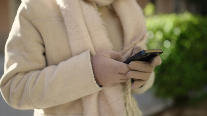 Young caucasian woman using smartphone at street
