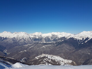 Naklejka premium Mountain peaks, blue sky, winter
