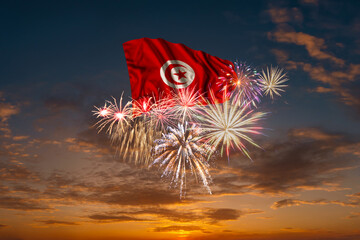 Flag of Tunisia and Holiday fireworks in sky - 570941386